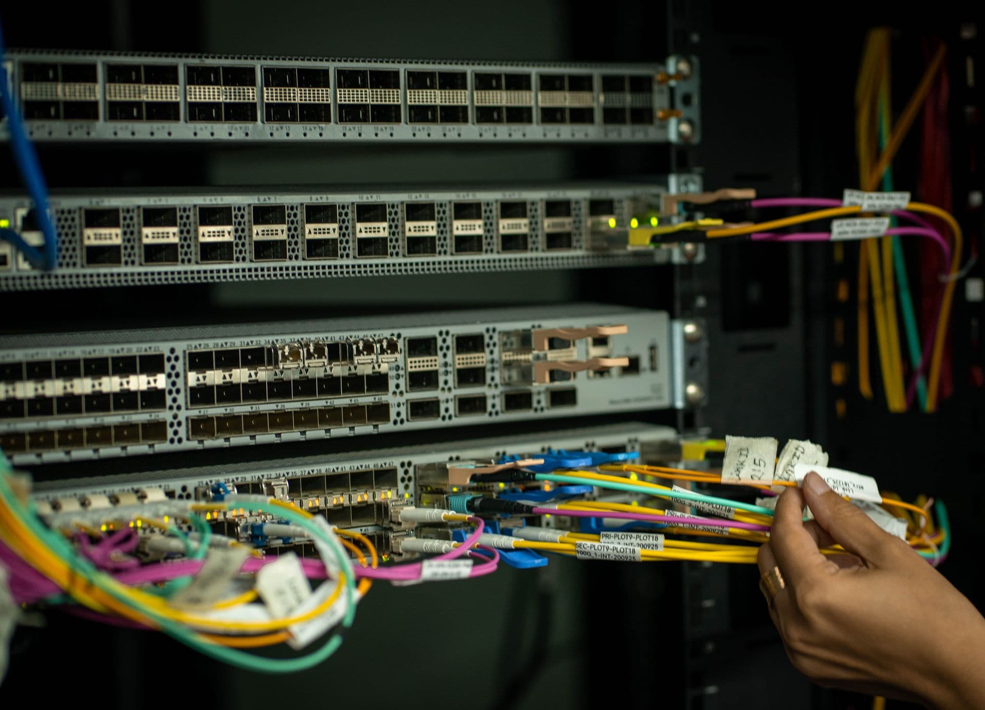 Technician working on fiber optic patch cables during installation